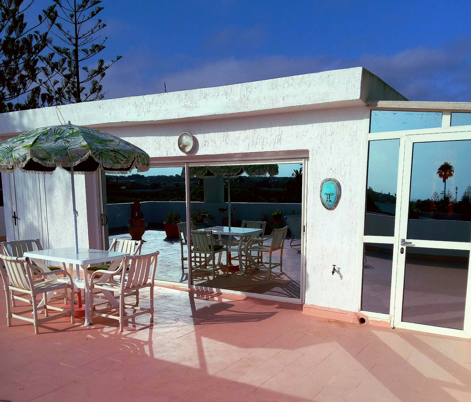 Terrace apartment — outdoor dining beneath the umbrella