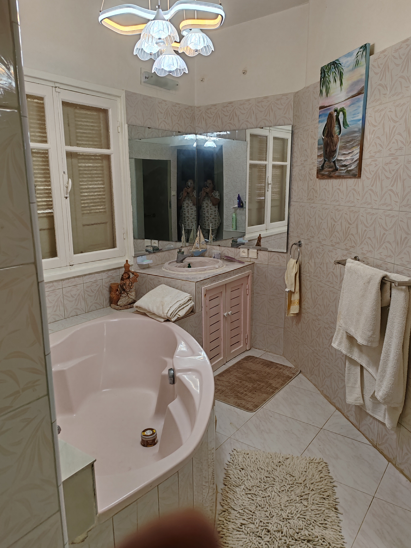 Second-floor bathroom — corner bathtub, vanity and large mirror