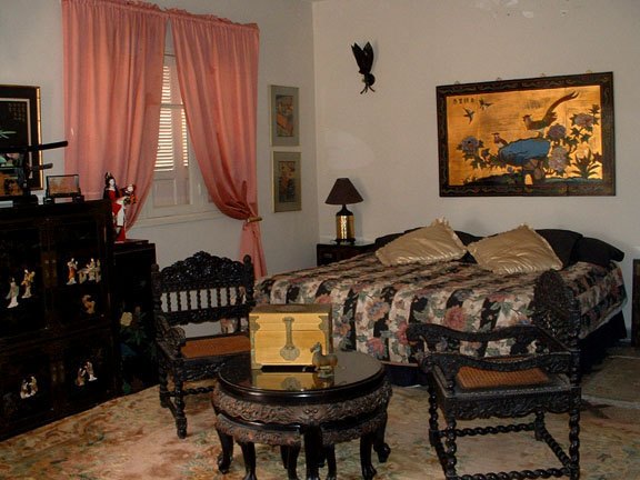 Master bedroom — two full-wall closets, direct access to the upper balcony