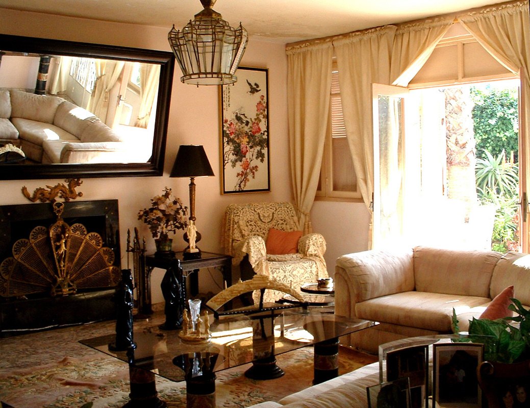 First-floor salon — marble floor and fireplace, opening to the garden patio