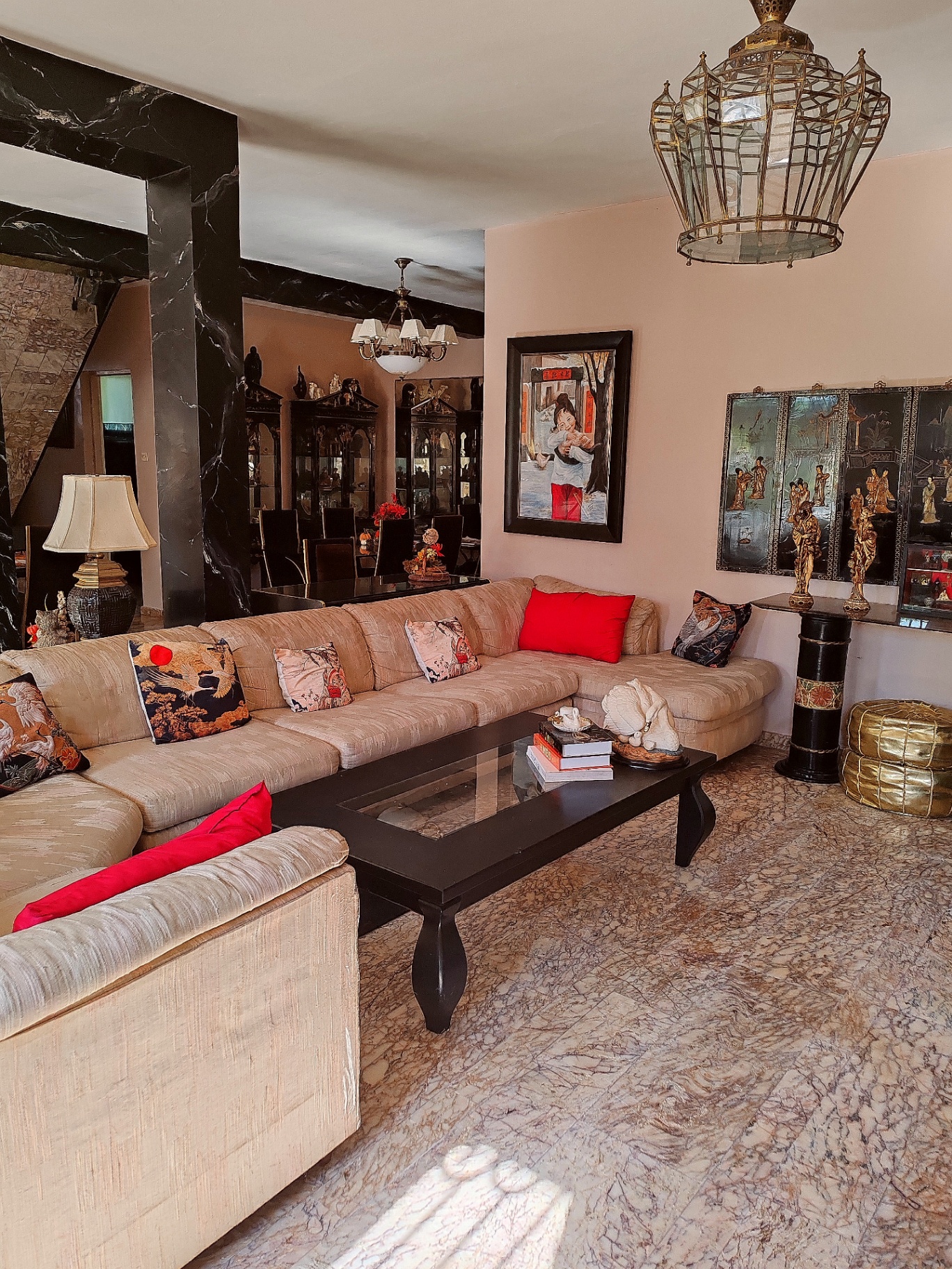 The same salon from the other side — black marble columns, the dining room beyond